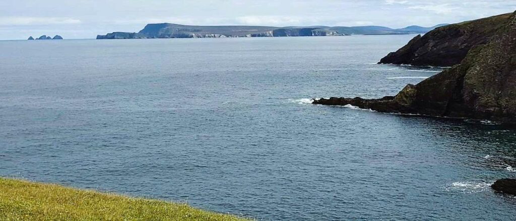 view across the sea from Erris head in county mayo, cliffs in distance