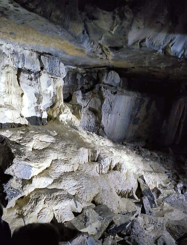 Aillwee Cave interior detail - lit up floor, side and ceiling of lime rock formations