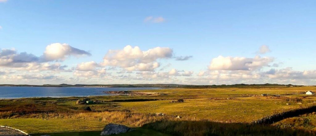 View across Bellderra Strand on Mullet Peninsula, grassy dunes, blue sea and white clouds