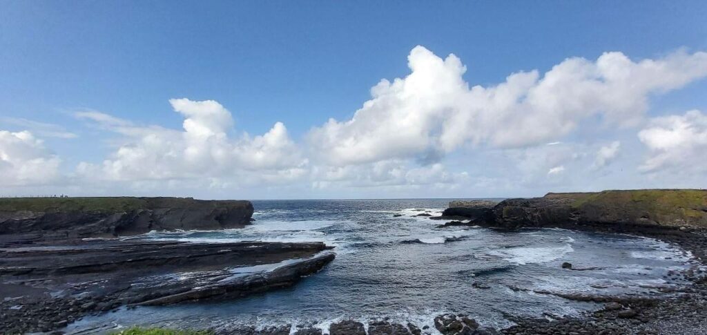 Lagoon at the bridges of ross, rocks on three sides and blue sea in the middle