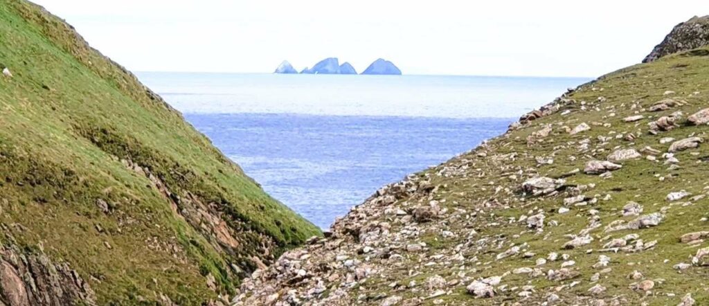 view over the sea from erris head loop walk towards rocks in the distance, broad haven stags