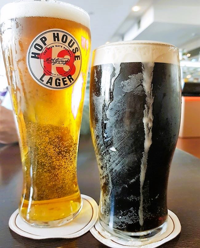 Two pints of beer next to each other, light lager on the left, dark guinness on the right, in mcdonnels bar weekend in belmullet