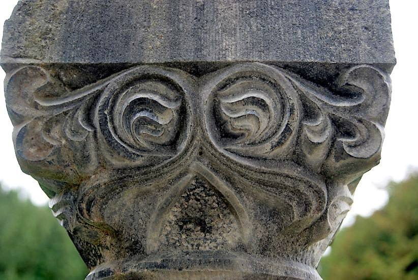 grey stone carved medieval detail of a column cap from cong abbey