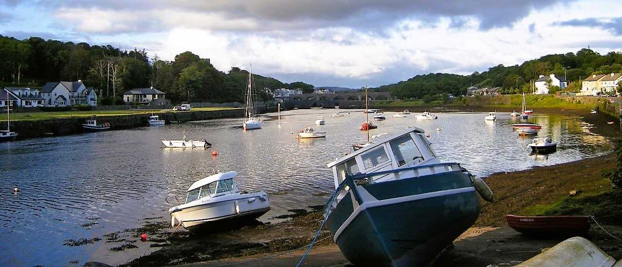 weekend in Cong and Lough Corrib - photo of two small boats on shore with river Cong behind them, forest on both sides