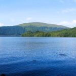 View of calm Loch Lomond on the west highland way, blue water with green gentle hills rising in the background